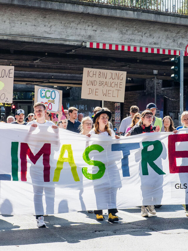 GLS Mitarbeiter*innen beim Klimastreik in Bochum mit einem Banner mit dem Schriftzug "Klimastreik"
